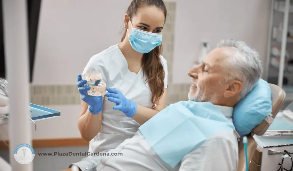 Plaza Dental in Gardena, CA. A patients on a dentist chair with a Dr. showing dentures