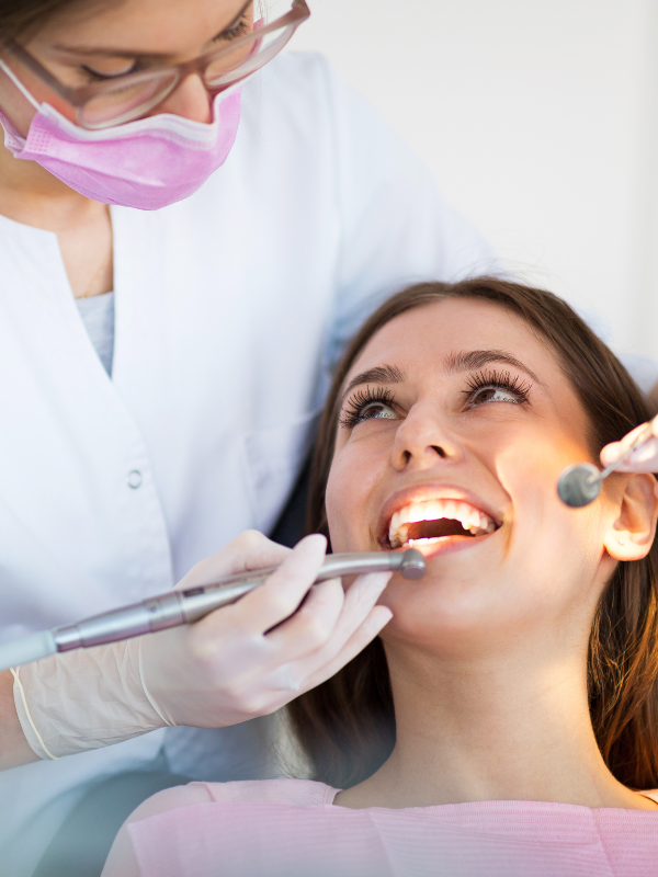 Dental Exam - Person Smiling at Dentist During Exam - Plaza Dental Specialty Group